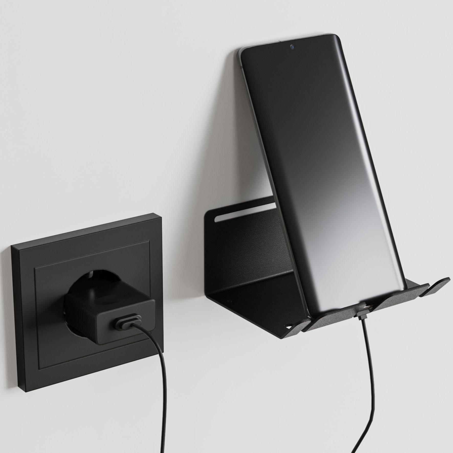 Μία μεταλλική βάση φόρτισης συσκευών με ένα κινητό που φορτίζει